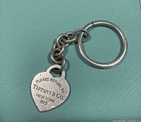 Front of heart-shaped tag showing “Please Return To Tiffany & Co. New York 925” engraving