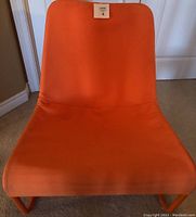 Front view of the orange IKEA Locksta chair showing fabric cover and seat shape.