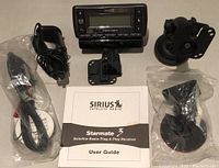Photo showing the Sirius Satellite Radio Starmate 3 unit, power adapter, antenna, two mounting brackets, cables, and user guide.