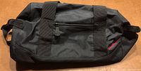 Front view of the black Walt Disney World duffel bag showing zipper pocket and handles.