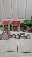 All 7 boxed village pieces from Dept 56 A Christmas Story series arranged together, showing boxes and packaging condition