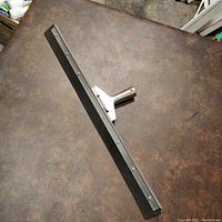 Top view of the 2 feet wide industrial floor squeegee showing the rubber blade and metal frame.