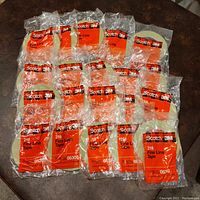 20 individually packaged rolls of 3M Scotch 218 Fine Line Tape arranged in 4 rows of 5 packs, each in clear plastic packaging with red and black plaid print.