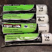 Four SHUR-LINE paint rollers in original packaging stacked showing brand and specifications.