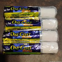 Four new Pintar One Coat Extra paint rollers sealed in plastic showing brand and specifications