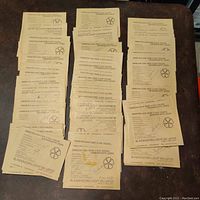 Multiple stacks of beige envelopes each labeled with text indicating stamps from various countries for visually impaired members of an organization.