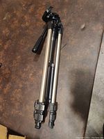 Tripod folded showing adjustable leg clamps and aluminum construction