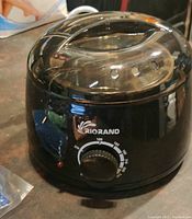 Black Griorand wax warmer pot with temperature dial and power light indicator.