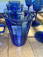 Close-up of sherbet cup showing cobalt blue glass with fluted vertical pattern and handle