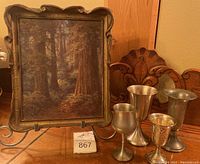 Painting on stand with four goblets arranged in front