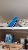 Shelf with two boxed soft wax kits, Aqua Globes box, and steam cleaner box visible below shelf