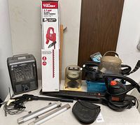 All items in the lot shown together: heater, hedge trimmer in box, lantern, blower, cords, shop lights and more
