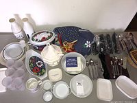 Overview of assorted dishes, serving pieces, milk bottles, napkins, and placemats