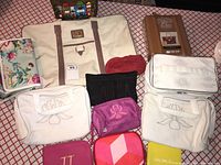 Overview of all bags and pouches on red and white grid fabric.
