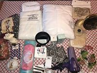 Photo of all items including packages, textiles, hairdryer, mirror, brushes, and decorative items.