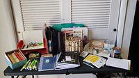 Overview of table with colored pencils, markers, notebooks, pens, folders, and various stationery supplies