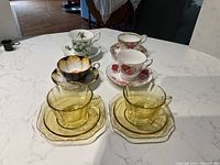 Full set of 6 cups and matching saucers, including four fine china and two amber glass sets