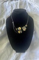 Front view of necklace on black display bust.