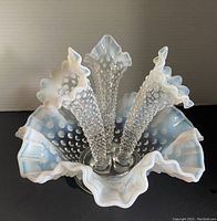 Top-down view showing the ruffled base and three hobnail textured horns slotting into the center, showing opalescent white sheen and hobnail pattern.
