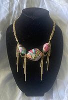 Full view of the Kara Ross necklace displayed on black jewelry bust showing whole necklace length, stones, and chain fringe detail.