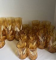 Front angle view of all amber wheat glasses arranged by size