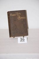 Front cover of the book showing title 'Hard Tack and Coffee' with gold embossing on brown cloth cover.