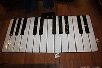 Full view of the large soft roll-up piano keyboard showing white and black keys, measuring approximately 69" by 30".