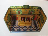 Full view of the Marx toy tin lithographed savings bank room showing the interior with detailed lithographic print and the bank teller section.