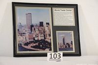 Framed souvenir featuring two matted color photographs of New York City World Trade Center and accompanying World Trade Center information text, under glass in a black frame.