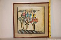 Front view of framed print showing the entire artwork and oak frame with measuring tape indicating size.