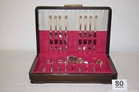 Full set of silverplate Del Mar flatware in wooden box with red velvet lining and white satin lid lining.