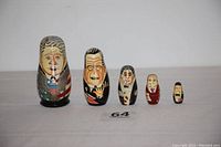 Full view of the 5-piece U.S. Presidents nesting dolls set aligned horizontally, detailed hand-painted faces and iconography.
