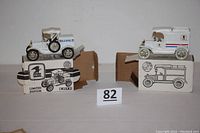 Both toy banks displayed on their original boxes showing scale and details.