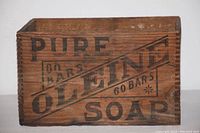 Front side of wooden box labeled '60 Bars Pure Oleine Soap' showing the large printed lettering and wood grain.