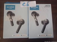 Two sealed retail boxes of Soundcore Life P2 wireless earbuds by Anker shown side by side on a flat surface.