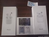 Three wireless earbuds sets in their retail packaging: two Pro 4 earbuds and one InPods 12 earbuds with color options.