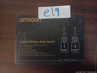 Photo of the packaging box for the Ammoon 2.4GHz Wireless Guitar System showing branding and product features