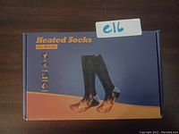 Box packaging for rechargeable battery heated socks, shows socks image with heating effect illustration.