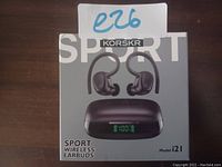 Front display of the unopened box showing KORSKR Sport Wireless Earbuds model i21 with image of earbuds and charging case with LCD battery display.