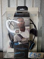 Packaging of the Pyle Flextreme PSWP6BK waterproof MP3 player with headphones, showing product branding and features