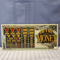 Full view of one slot machine glass panel showing payout table and IN THE MONEY graphics