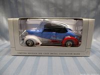 Blue, white, and red die cast 1937 Ford car coin bank with Dairy Queen branding in original box.