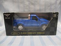 Blue Ford F-350 concept truck die cast model inside original box showing side and front details.