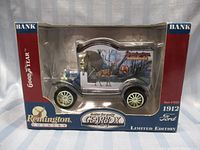 Full view of the Gearbox 1:24 scale white 1912 Ford coin bank in original box with Remington Country artwork and Goodyear branding.