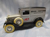 Side view of Silver Ford Model A diecast car with Sears Craftsman branding and spare wheel.