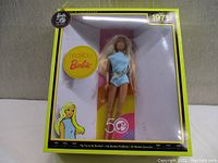 Front view of Malibu Barbie in original box with 50th Anniversary branding and 1971 year, wearing light blue swimsuit.
