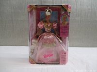 Full front view of Rapunzel Barbie in original box, showing pink gown and crown