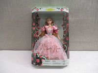 Front view of Rose Barbie doll in original box, showing floral box design and clear display window.