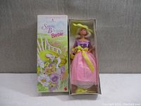 Front view of Barbie doll in original box, showing doll's outfit and box artwork.