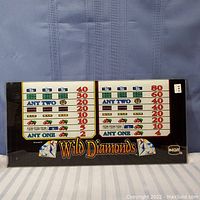 Full view of the Wild Diamonds slot machine glass panel, showing payout details, graphics, and logos.